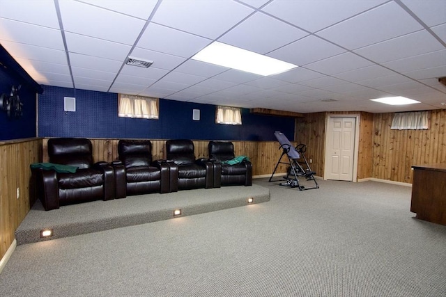 carpeted home theater with wood walls