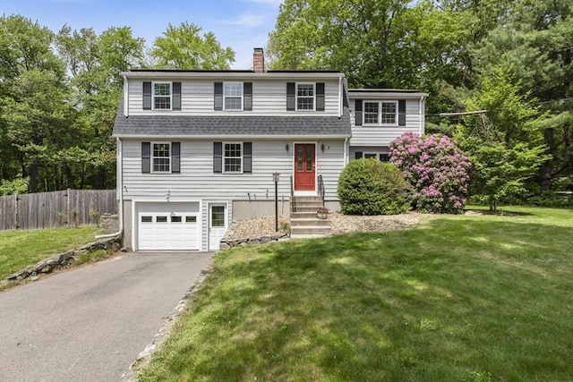 3 Howe St, Medway, MA 02053 - view of front facade featuring driveway, a chimney, an attached garage, and a shingled roof