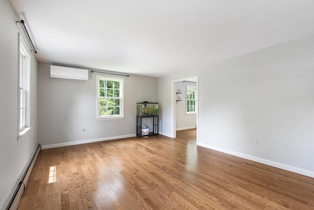 3 Howe St, Medway, MA 02053 - unfurnished living room featuring a baseboard radiator, an AC wall unit, light wood-style flooring, and baseboards