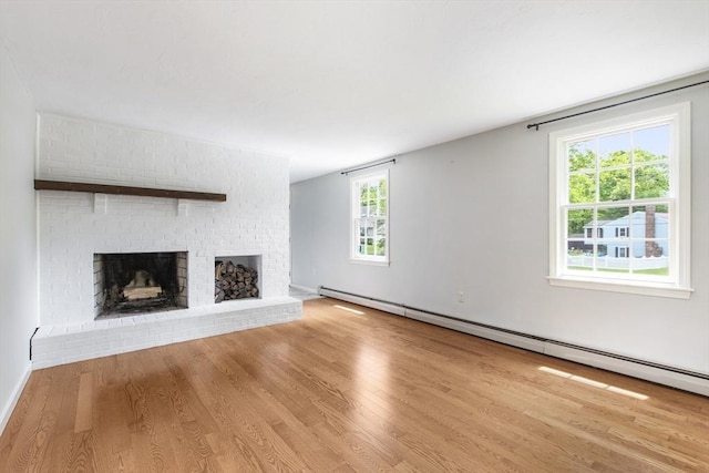 3 Howe St, Medway, MA 02053 - unfurnished living room with a baseboard heating unit, a fireplace, wood finished floors, and healthy amount of natural light