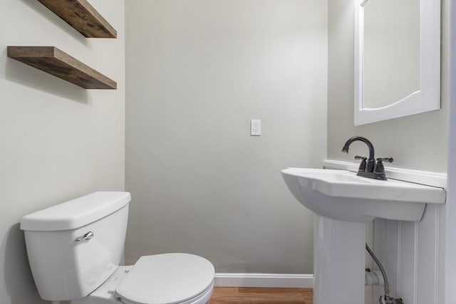 3 Howe St, Medway, MA 02053 - half bathroom featuring toilet, wood finished floors, and baseboards