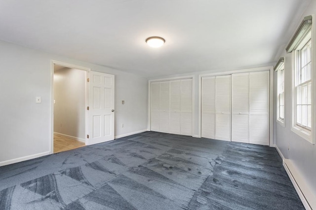 3 Howe St, Medway, MA 02053 - unfurnished bedroom with a baseboard heating unit, carpet floors, multiple closets, and multiple windows