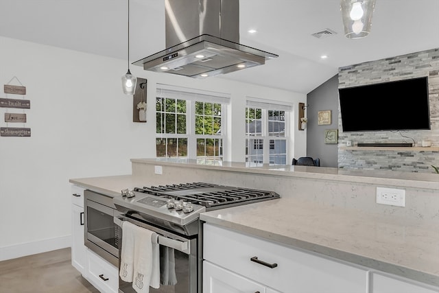 kitchen with white cabinetry, stainless steel appliances, island range hood, hanging light fixtures, and lofted ceiling