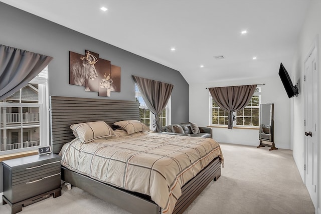 carpeted bedroom with vaulted ceiling