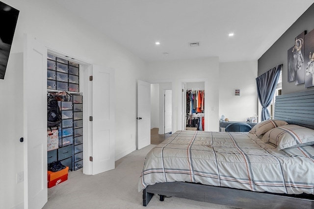 bedroom with a closet and light carpet