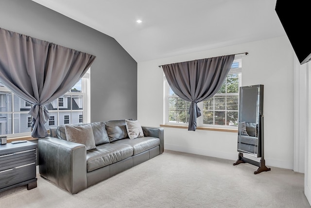 living room featuring lofted ceiling and light carpet