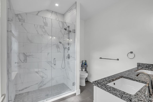 bathroom featuring tile patterned flooring, vanity, toilet, and walk in shower