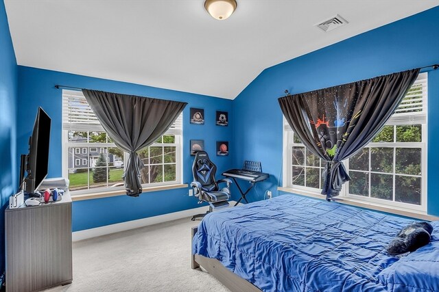 bedroom with lofted ceiling, carpet floors, and multiple windows