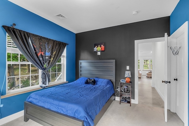 bedroom featuring light colored carpet