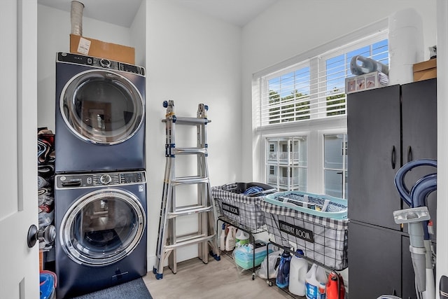 laundry area with stacked washer and dryer