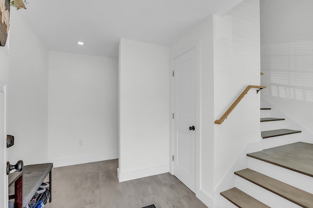 stairs featuring hardwood / wood-style flooring