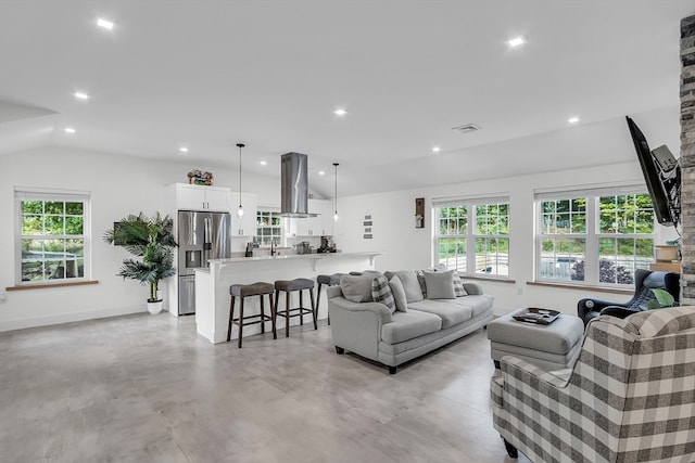 living room featuring a wealth of natural light and lofted ceiling