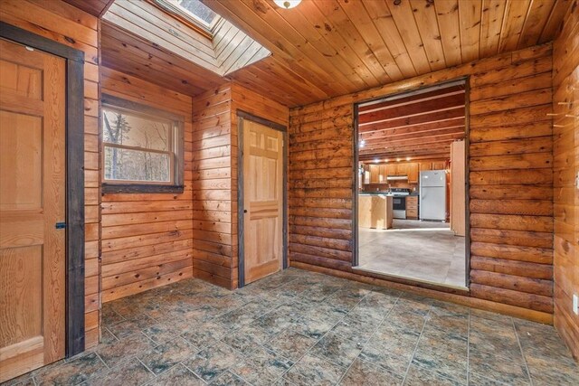 spare room with wood ceiling, rustic walls, and a skylight