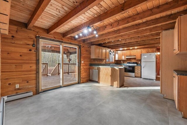 kitchen with white appliances, a kitchen island, a healthy amount of sunlight, and wood walls