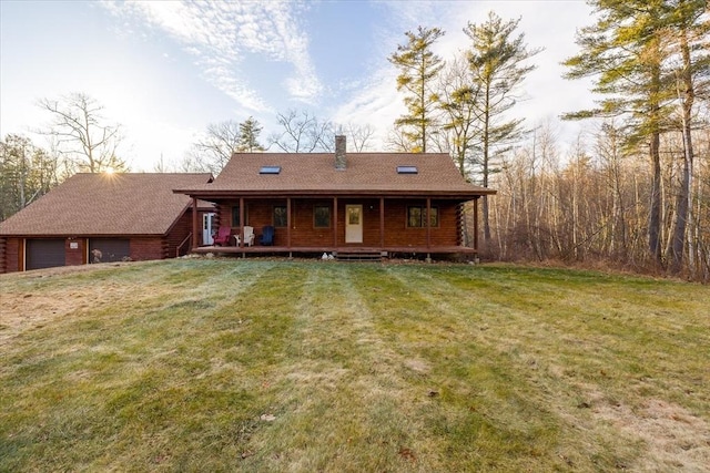 rear view of property featuring a lawn and a porch