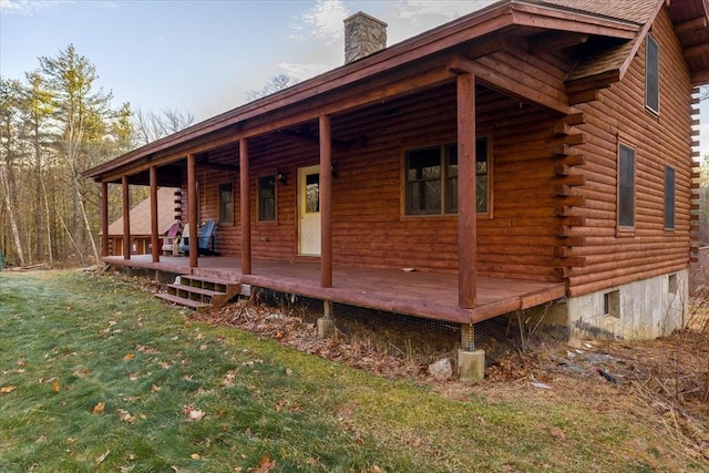 view of property exterior with a lawn and a porch