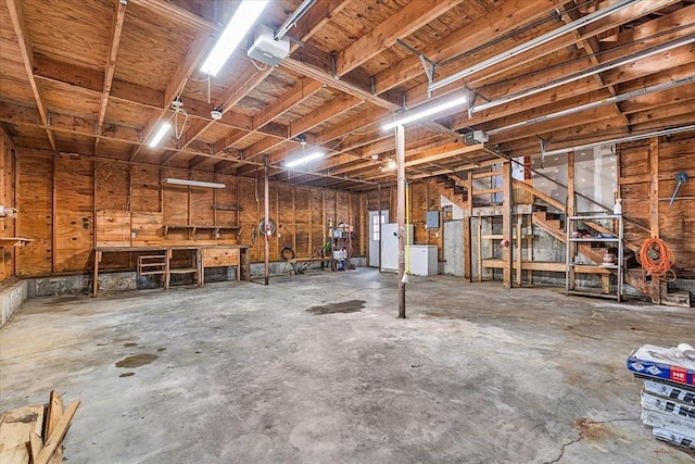 garage featuring a workshop area and a garage door opener