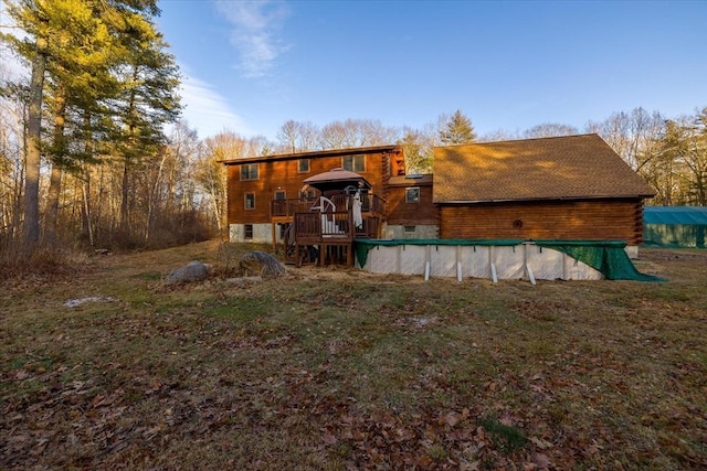 rear view of property with a wooden deck