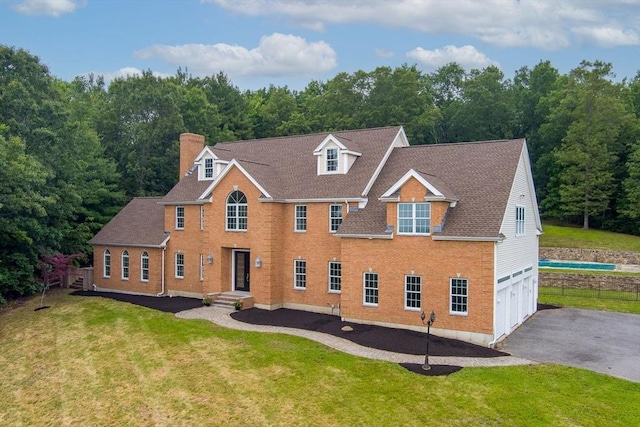 17 Arrowhead Ln, Westborough, MA 01581 - view of front of property with an attached garage, driveway, a chimney, brick siding, and a forest view