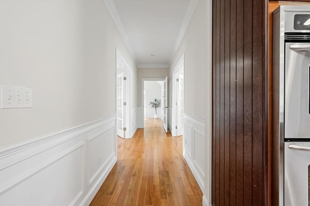 17 Arrowhead Ln, Westborough, MA 01581 - hallway featuring ornamental molding, wainscoting, light wood-style flooring, and a decorative wall