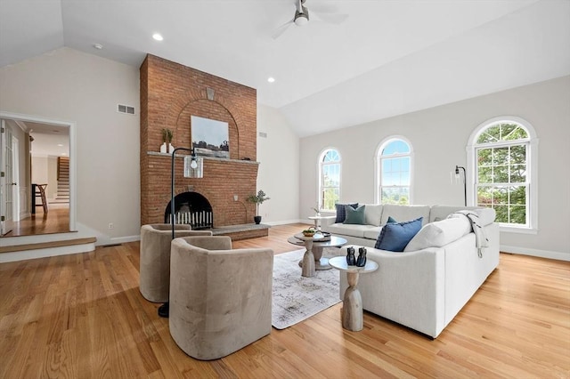17 Arrowhead Ln, Westborough, MA 01581 - living area featuring wood finished floors, a ceiling fan, high vaulted ceiling, and a brick fireplace