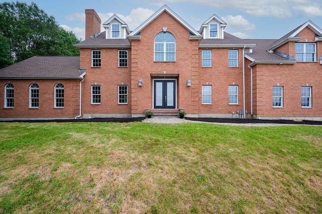 17 Arrowhead Ln, Westborough, MA 01581 - view of front of home with french doors, brick siding, a front lawn, and a chimney