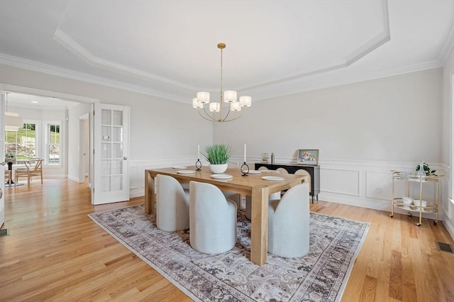 17 Arrowhead Ln, Westborough, MA 01581 - dining area featuring a raised ceiling, a chandelier, light wood finished floors, crown molding, and wainscoting