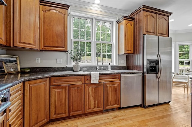 17 Arrowhead Ln, Westborough, MA 01581 - kitchen featuring stainless steel appliances, ornamental molding, light wood finished floors, brown cabinets, and dark stone countertops