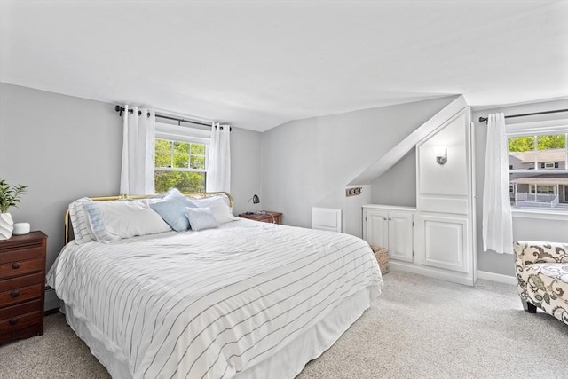 bedroom featuring light colored carpet and lofted ceiling