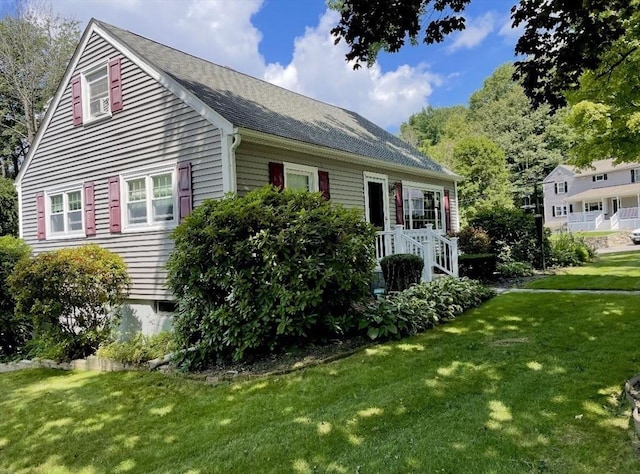 view of side of home with a lawn