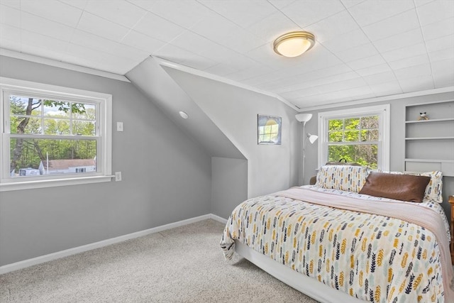 bedroom with multiple windows, carpet flooring, baseboards, and vaulted ceiling