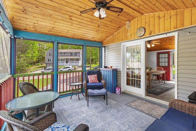 sunroom with a ceiling fan and lofted ceiling