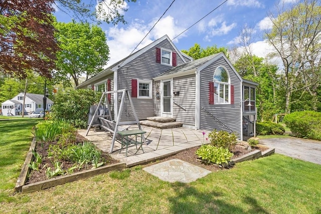 back of house featuring a yard and a patio area