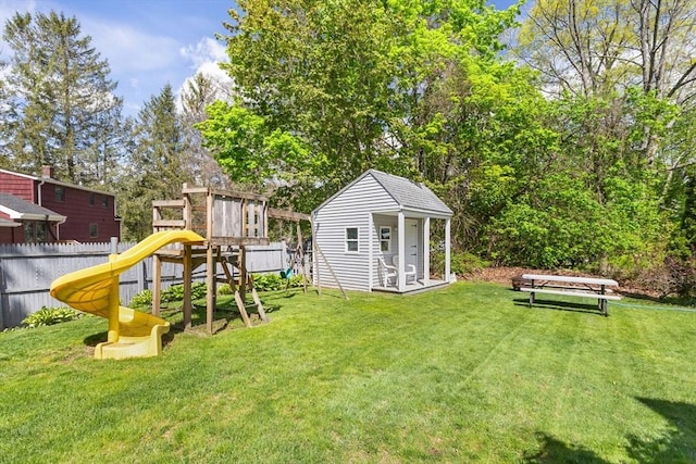 view of yard with a playground and an outbuilding