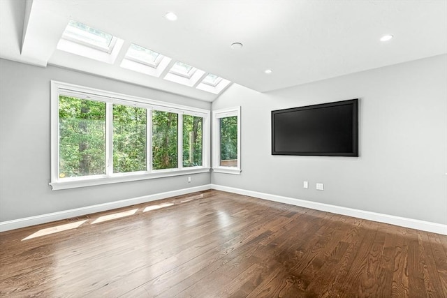 7 Wainwright Rd Unit 55, Winchester, MA 01890 - unfurnished room with a skylight, baseboards, wood finished floors, vaulted ceiling, and recessed lighting