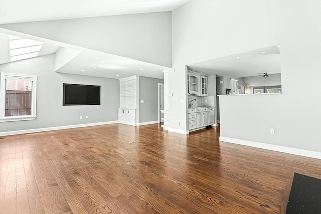 7 Wainwright Rd Unit 55, Winchester, MA 01890 - unfurnished living room with wood finished floors, high vaulted ceiling, and baseboards