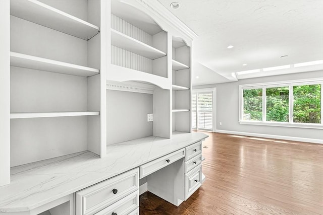 7 Wainwright Rd Unit 55, Winchester, MA 01890 - unfurnished office with built in study area, dark wood finished floors, built in shelves, recessed lighting, and baseboards