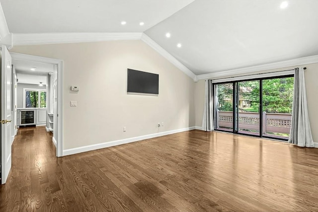 7 Wainwright Rd Unit 55, Winchester, MA 01890 - unfurnished living room with beverage cooler, vaulted ceiling, dark wood-type flooring, baseboards, and crown molding