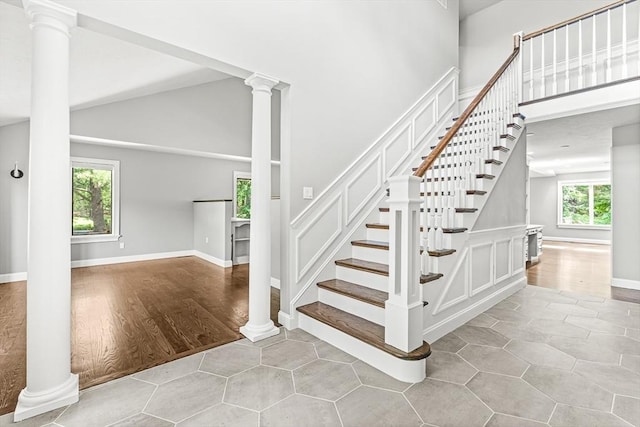 7 Wainwright Rd Unit 55, Winchester, MA 01890 - staircase featuring high vaulted ceiling, ornate columns, and baseboards