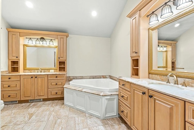 7 Wainwright Rd Unit 55, Winchester, MA 01890 - full bathroom featuring two vanities, a garden tub, recessed lighting, and vaulted ceiling