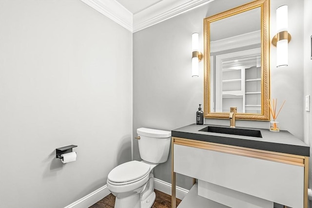 7 Wainwright Rd Unit 55, Winchester, MA 01890 - half bathroom featuring ornamental molding, toilet, baseboards, vanity, and wood finished floors