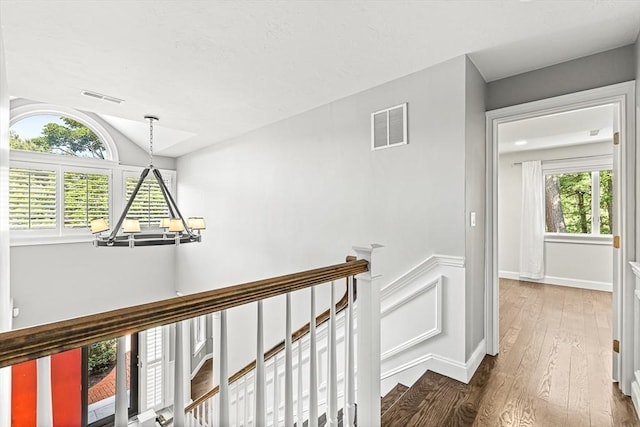 7 Wainwright Rd Unit 55, Winchester, MA 01890 - hallway featuring an upstairs landing, wood finished floors, and vaulted ceiling