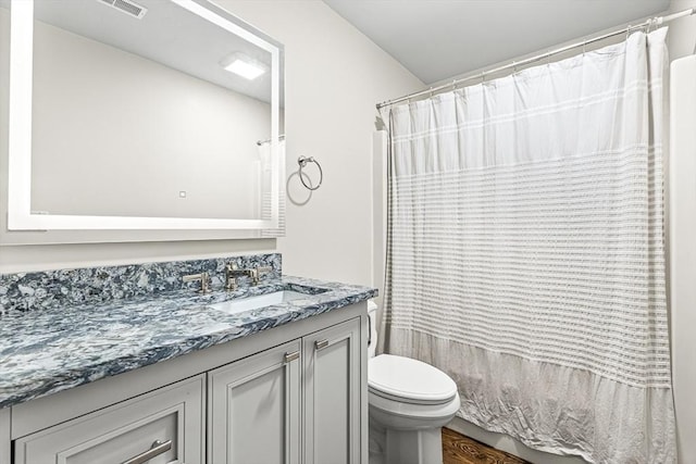 7 Wainwright Rd Unit 55, Winchester, MA 01890 - full bathroom with vanity, toilet, wood finished floors, and a shower with curtain
