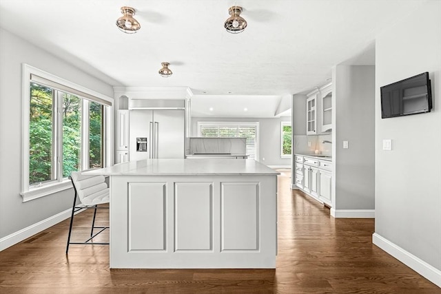 7 Wainwright Rd Unit 55, Winchester, MA 01890 - kitchen with stainless steel built in fridge, baseboards, a center island, glass insert cabinets, and light countertops