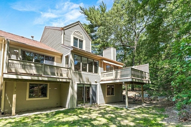 7 Wainwright Rd Unit 55, Winchester, MA 01890 - back of house with a chimney, a yard, and a wooden deck