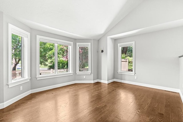7 Wainwright Rd Unit 55, Winchester, MA 01890 - unfurnished room featuring plenty of natural light, wood finished floors, baseboards, and lofted ceiling