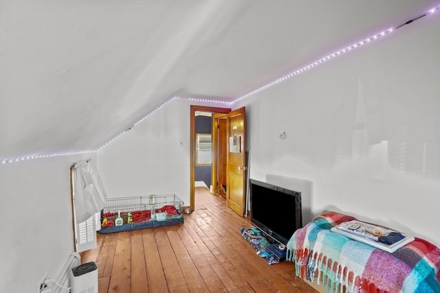 bedroom featuring vaulted ceiling and hardwood / wood-style flooring