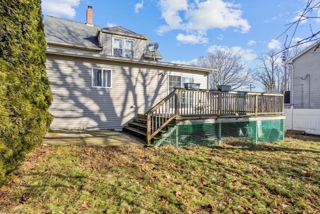 back of house with a lawn and a wooden deck