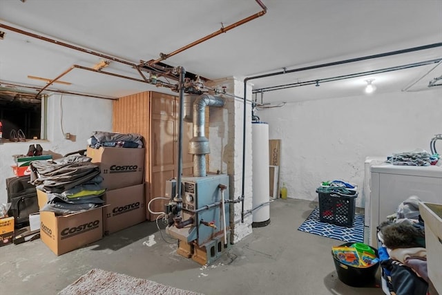 basement featuring water heater and washer / clothes dryer