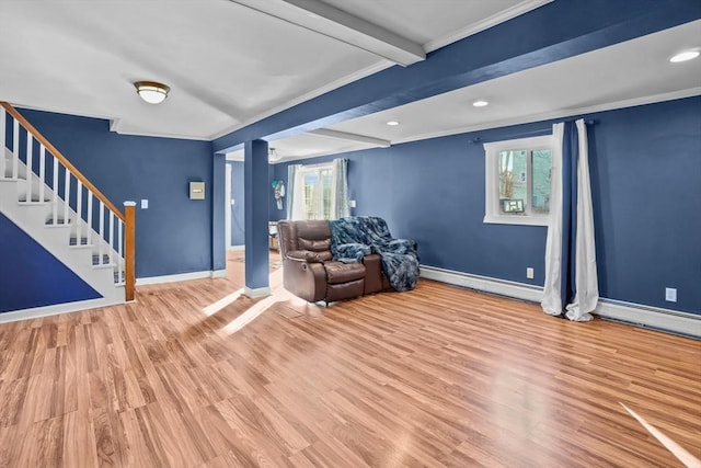 unfurnished living room with baseboard heating, ornamental molding, beam ceiling, and light hardwood / wood-style flooring